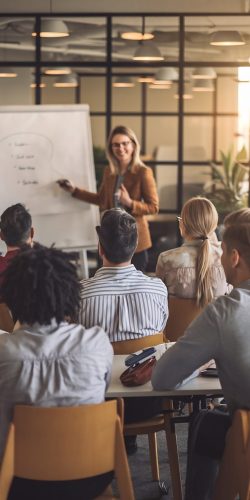 diverse-group-adult-learners-listening-presentation-from-female-renown-educator-office-meet